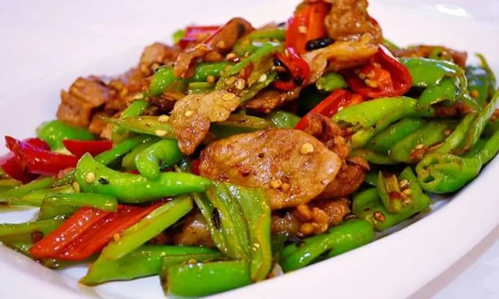 AURA-Restaurant-Asian-Restaurant-Stir-Fried-Pork-with-Green-Peppers-Santa-Barbara Juicy pork stir-fried with green peppers at AURA-Restaurant, a Asian Restaurant in Santa Barbara.